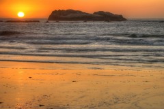 Sunset at Trinidad State Beach with Flatiron Rock in the distance